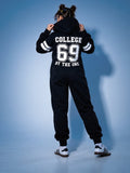 69 black jumpsuit, back view: COLLEGE 69 print, lower back covered | THE ONE