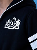 Embroidered crest on the 69 black jumpsuit, close-up | THE ONE