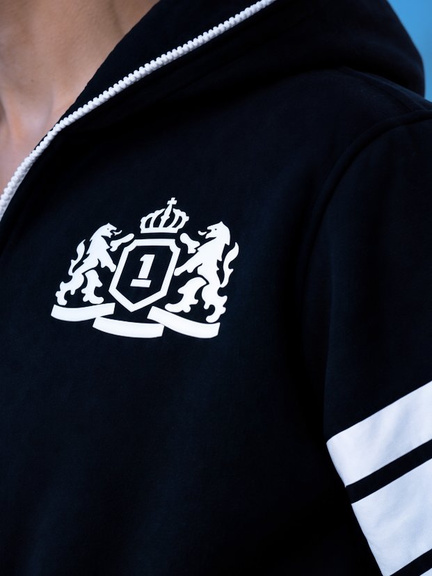 Embroidered crest on the 69 black jumpsuit, close-up | THE ONE