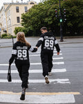 Couple in 69 black jumpsuits crossing the street: family look | THE ONE