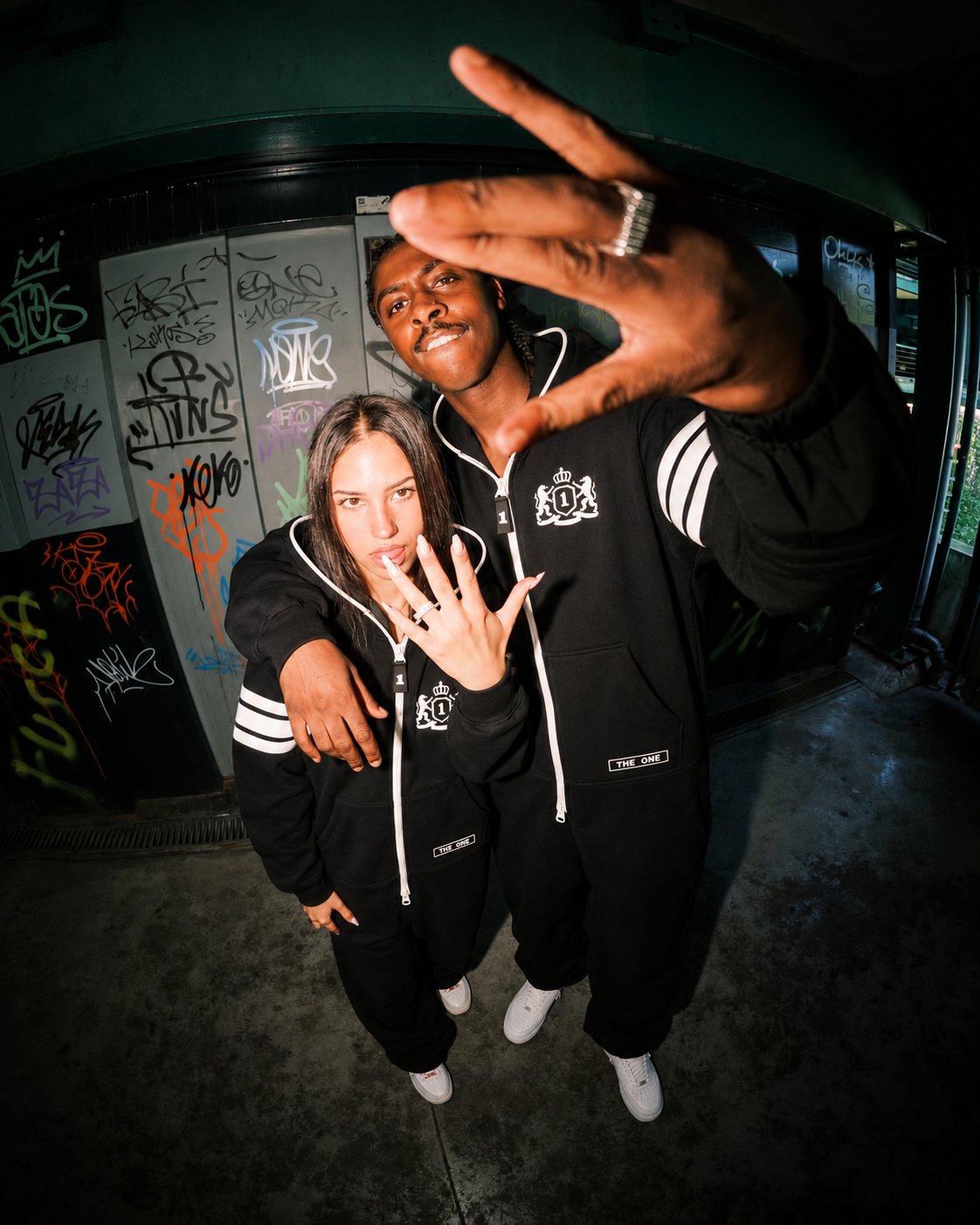 Couple in 69 black jumpsuits at night in the city | THE ONE