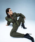 Aviator khaki jumpsuit with patches, studio shot | THE ONE