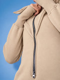 Ninja beige jumpsuit close-up: massive zipper and dense knit | THE ONE