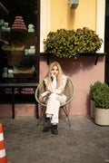 Ninja beige jumpsuit sitting in a cafe chair: comfortable, nothing presses | THE ONE
