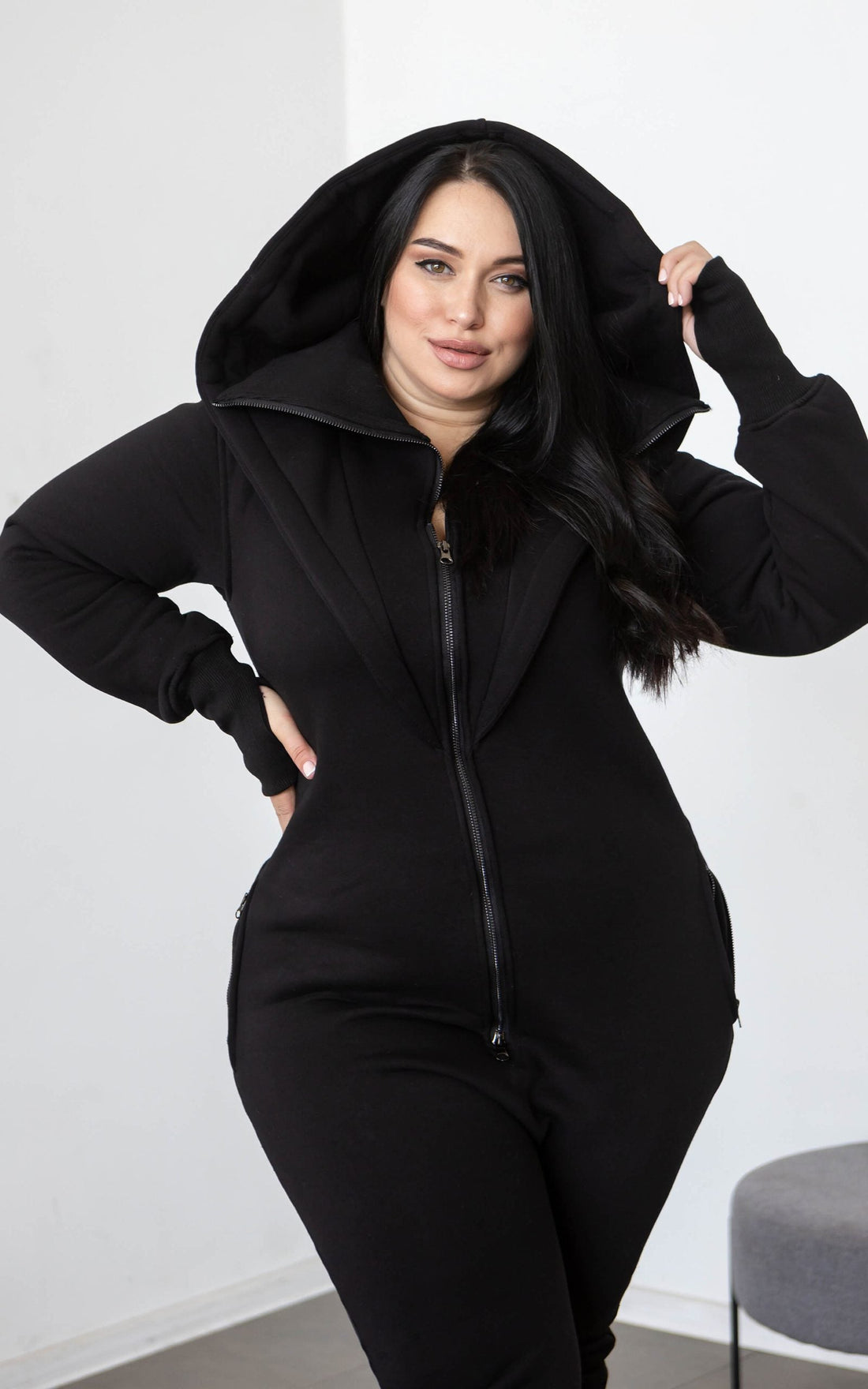 Ninja black jumpsuit with its huge hood up: hourglass silhouette on a curvy figure | THE ONE