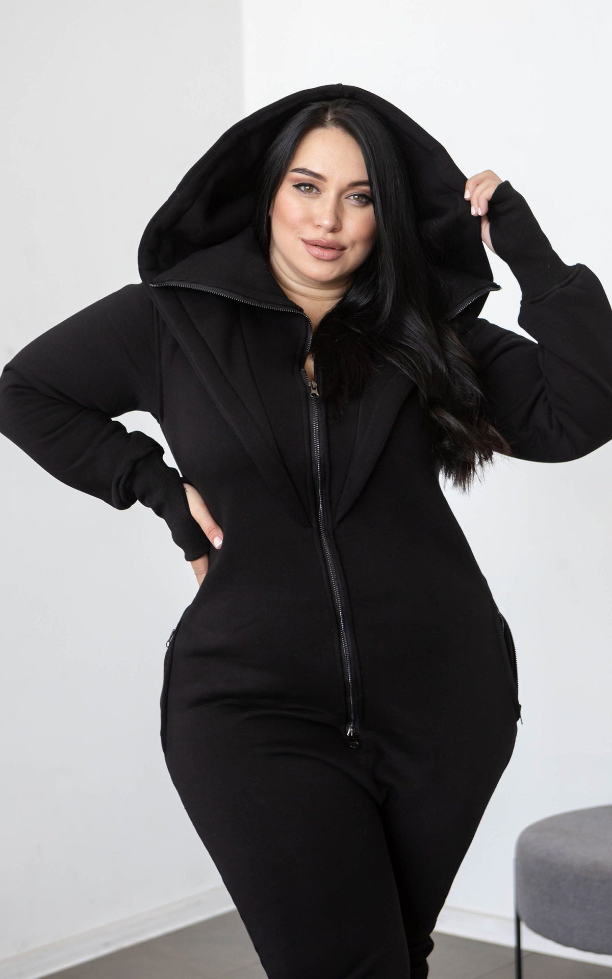 Ninja black jumpsuit with its huge hood up: hourglass silhouette on a curvy figure | THE ONE