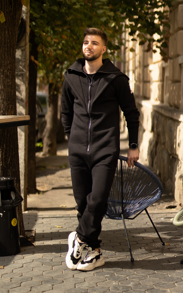 Men's warm jumpsuit Ninja black on a city street: minimalist one-piece look | THE ONE
