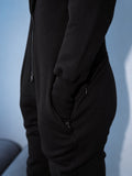 Ninja black jumpsuit, hand in a zippered pocket | THE ONE