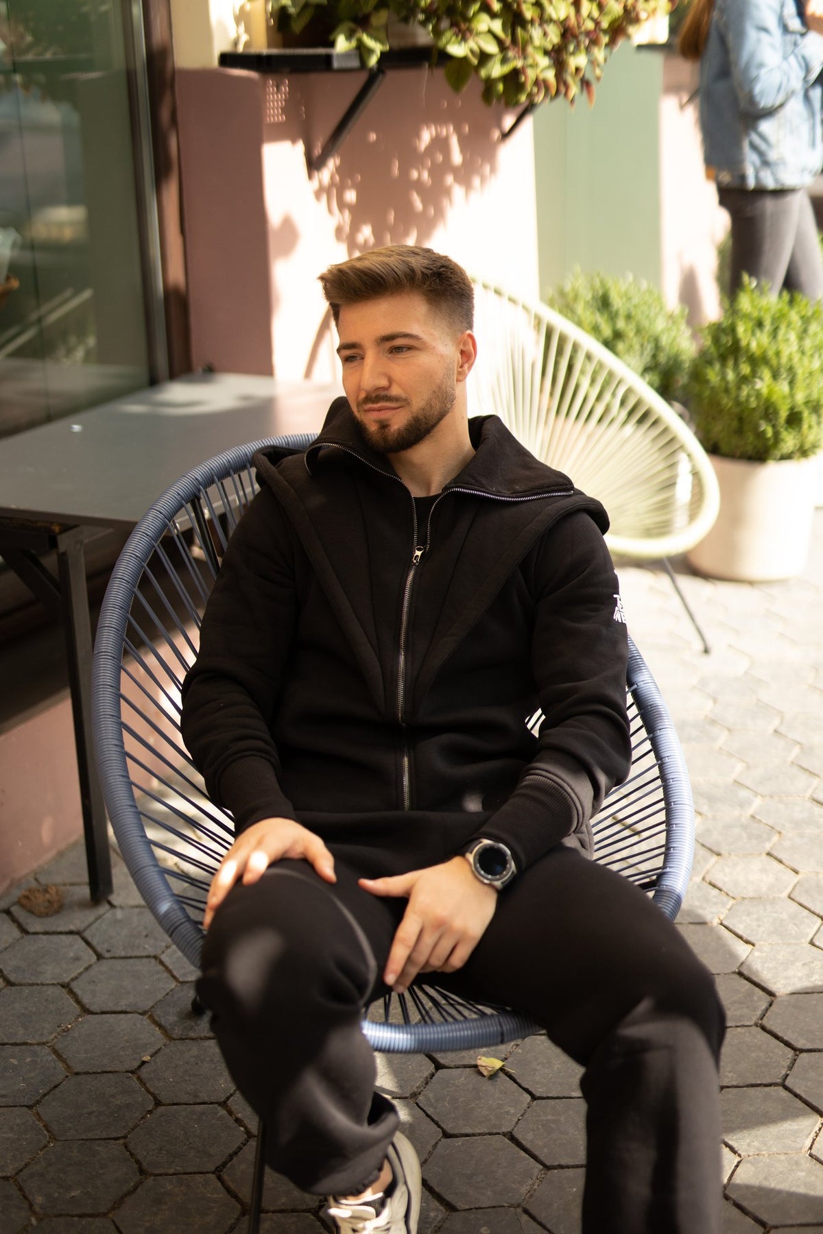 Ninja black jumpsuit sitting in a cafe chair: comfortable, nothing presses | THE ONE
