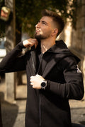 Ninja black jumpsuit close-up: massive zipper and dense knit | THE ONE