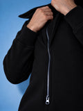 Ninja black jumpsuit close-up: massive zipper and dense knit | THE ONE