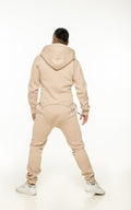 Original beige jumpsuit, back view: one-piece cut, back covered | THE ONE