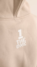THE ONE print on the back of the Original beige jumpsuit, close-up | THE ONE