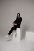 Original navy jumpsuit, sitting on a cube: back stays covered | THE ONE