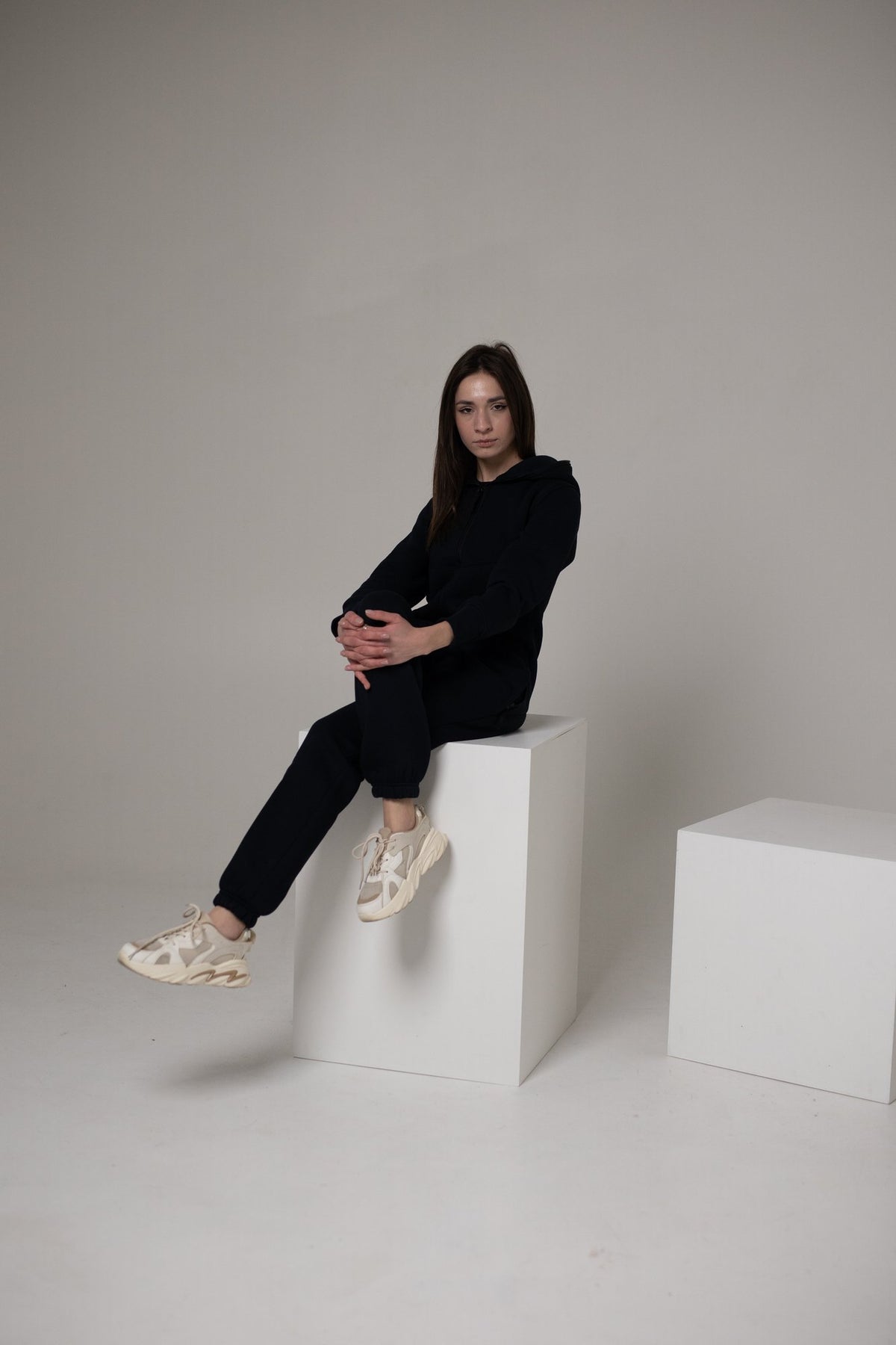 Original navy jumpsuit, sitting on a cube: back stays covered | THE ONE