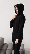 Original black jumpsuit with hood up, side view | THE ONE