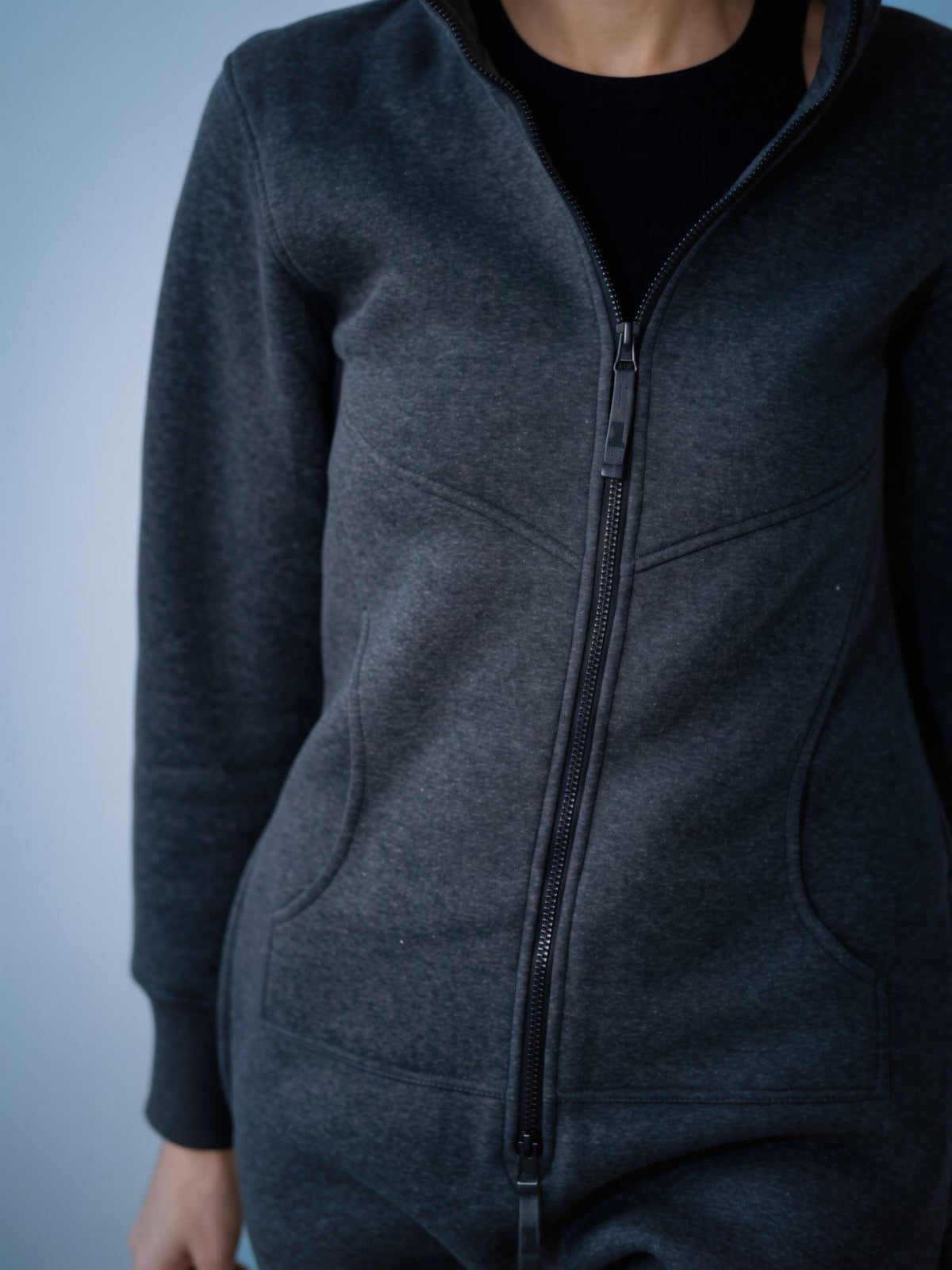 Original graphite jumpsuit close-up: dense knit and full-length zipper | THE ONE