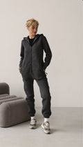 Original graphite jumpsuit, hands in pockets, full length | THE ONE