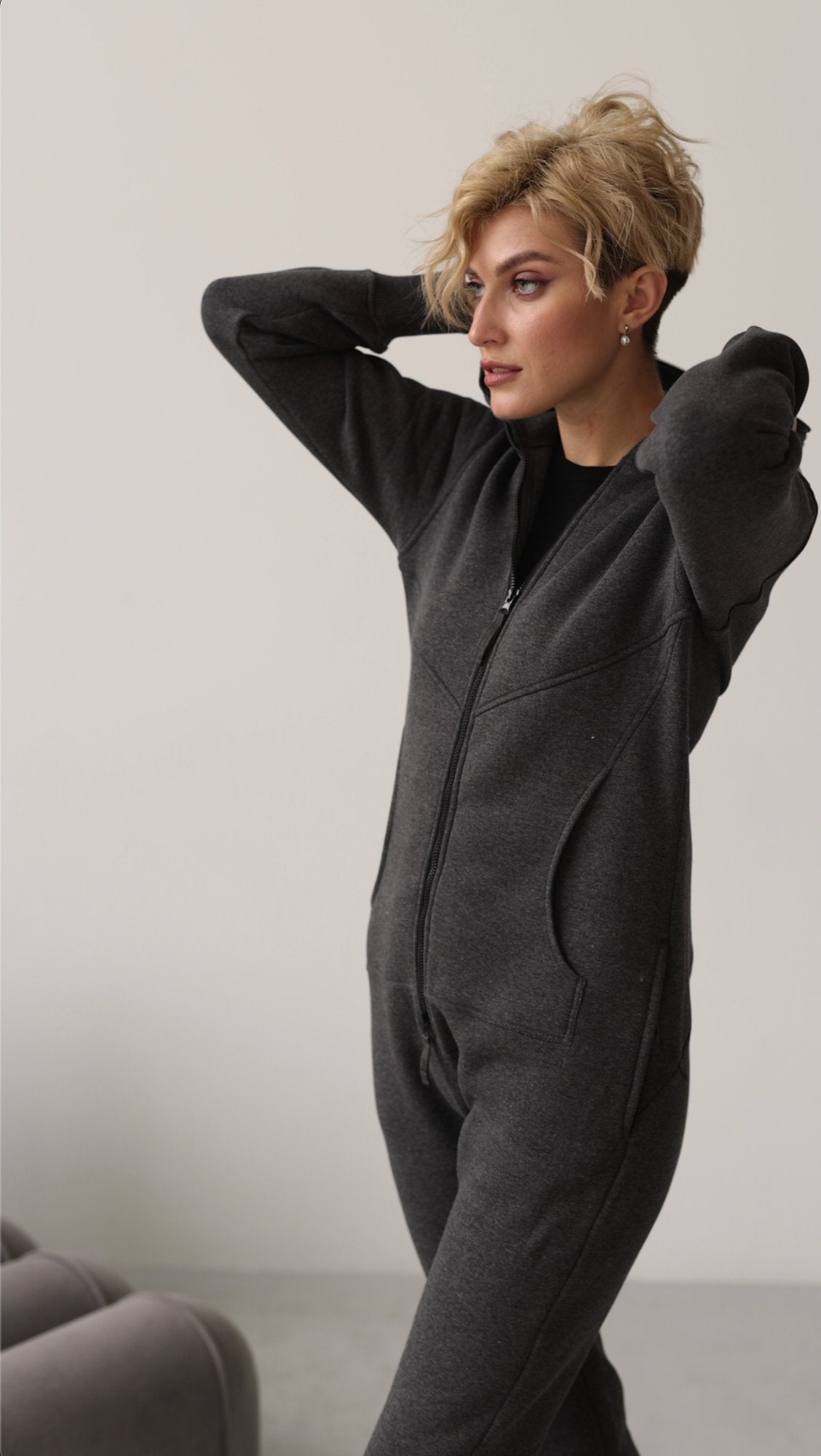 Original graphite jumpsuit, arms raised: moves freely | THE ONE