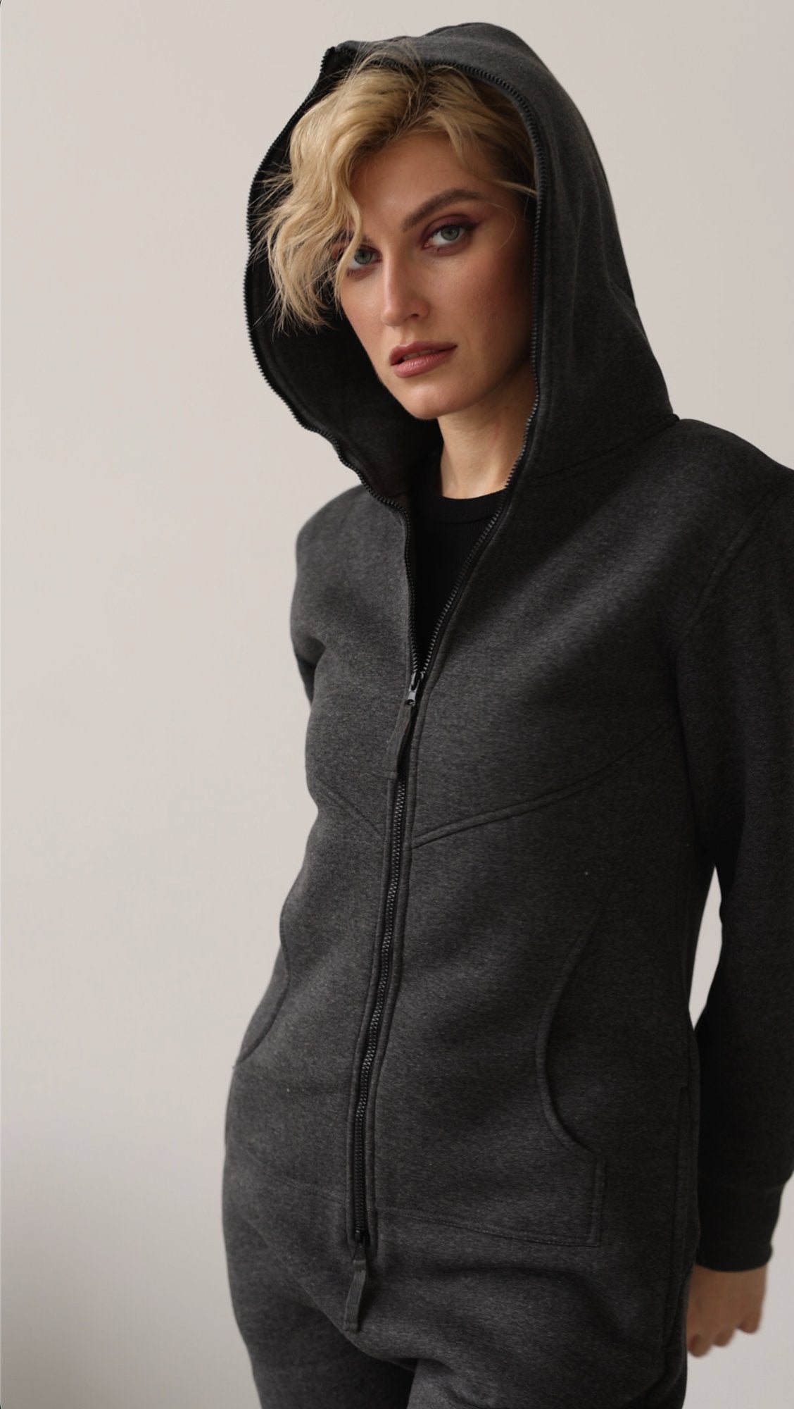 Original graphite jumpsuit with hood on, close-up | THE ONE