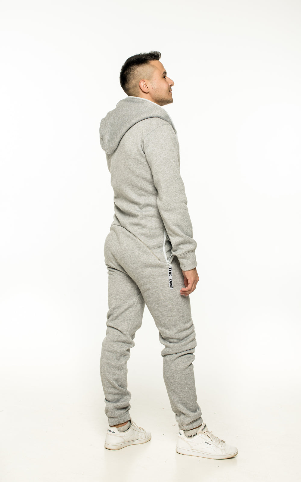 Original grey jumpsuit, back view: one-piece cut, back covered | THE ONE
