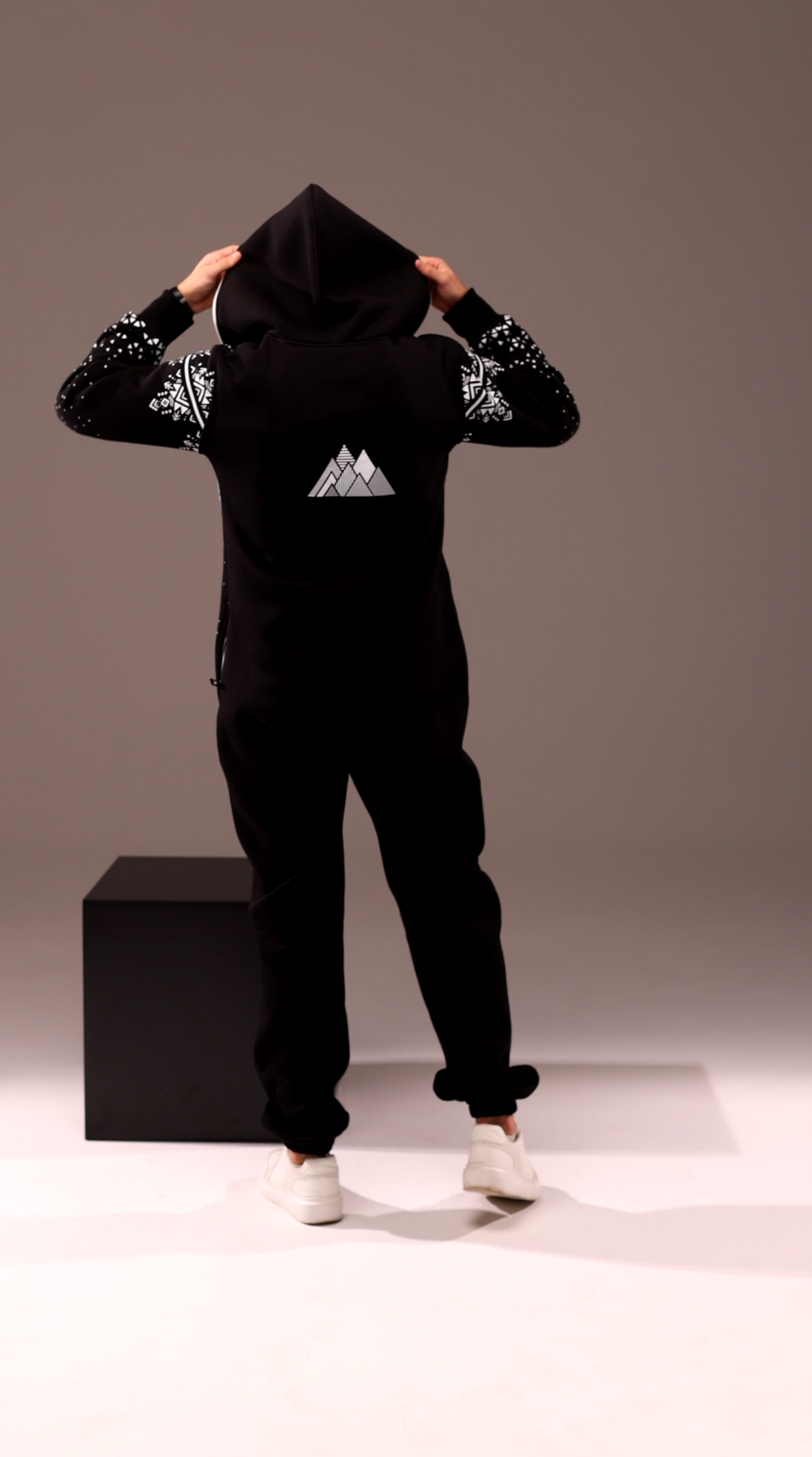 Men's Snowy black jumpsuit with hood up, back view | THE ONE
