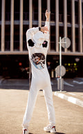 Space X white jumpsuit on a city street, back view: astronaut print, hood up | THE ONE